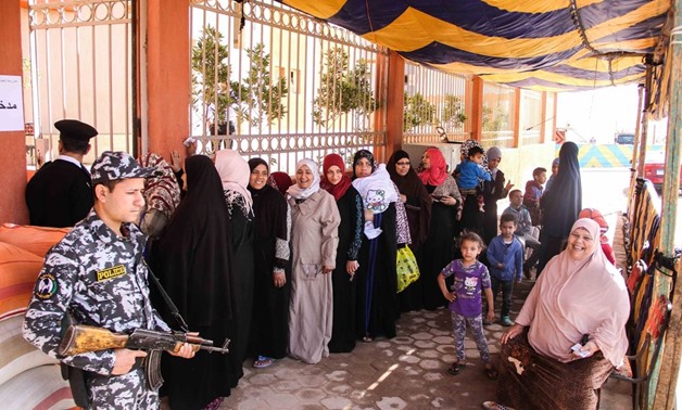Women wait in line to vote at a polling station in Asmarat housing project area on March 27, 2018 - Mohamed Fawzy