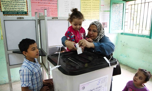 A woman casts her vote in a school in Dokki, Giza on March 28, 2018 - Hassan Mohamed