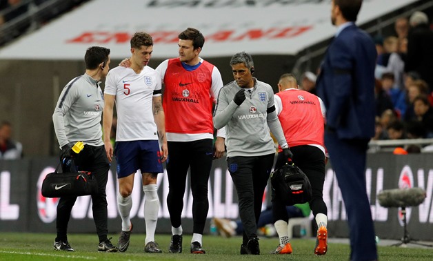 Soccer Football - International Friendly - England vs Italy - Wembley Stadium, London, Britain - March 27, 2018 England's John Stones is substituted off after sustaining an injury as Harry Maguire looks on REUTERS/Darren Staples
