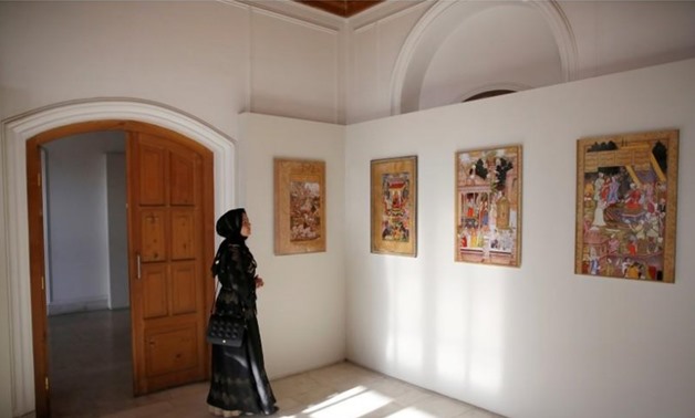 An Afghan woman looks at art exhibition at Babur Garden in Kabul, Afghanistan March 31, 2018. Picture taken March 31, 2018. REUTERS/Mohammad Ismail
