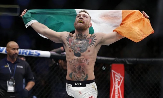 Nov 12, 2016; New York, NY, USA; Conor McGregor (blue gloves) celebrates after defeating Eddie Alvarez (red gloves) in their lightweight title bout during UFC 205 at Madison Square Garden. Mandatory Credit: Adam Hunger-USA TODAY Sports