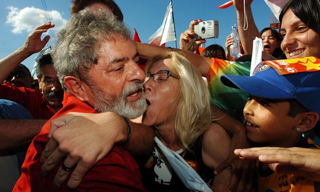 Brazilian President Luiz Inacio Lula da Silva is mobbed by supporters while on a visit as part of his campaign for re-election in Porto Alegre, southern Brazil, October 21, 2006. REUTERS/Diego Vara/File Photo