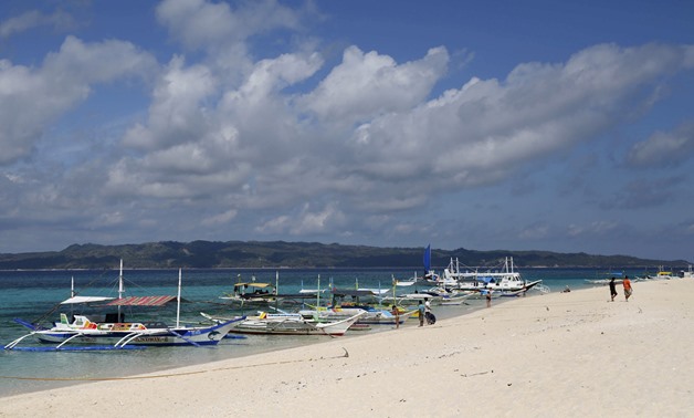 Traditional boats line up the shore in a secluded beach on the island of Boracay, central Philippines January 18, 2016. REUTERS/Charlie Saceda/File Photo