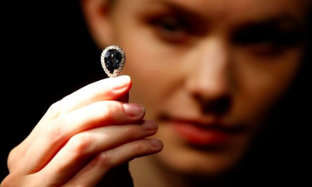A model poses with 'The Farnese Blue' diamond at Sotheby's auction house in London, Britain, April 6, 2018. REUTERS/Henry Nicholls
