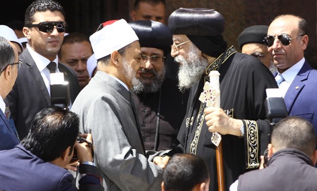 Grand Imam of Azhar Ahmed el-Tayyib shakes hands with Pope Tawadros outside the cathedral after Easter celebrations on April 8, 2018 - Photo by Mahmoud Fakhry/Egypt Today