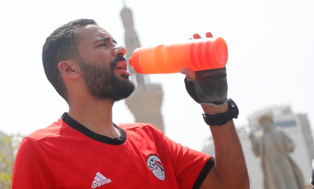 Egyptian cyclist Mohamed Nofal drinks water in front of Omar Makram mosque before his journey to Russia for the 2018 Fifa World Cup after Egypt qualified for the first time in 28 years, in Cairo, Egypt, April 7, 2018. REUTERS/Amr Abdallah Dalsh
