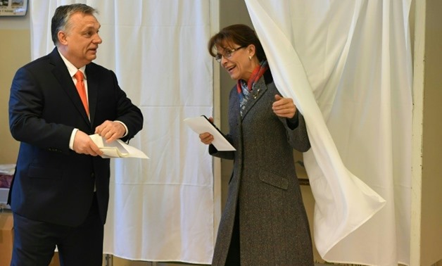 Hungarian Prime Minister Viktor Orban (L) and his wife Aniko Levai(R) vote at a polling station located ina school in Budapest.
