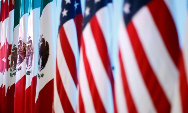 Flags of Canada, Mexico and the U.S. are seen before a joint news conference on the closing of the seventh round of NAFTA talks in Mexico City, Mexico March 5, 2018. REUTERS/Edgard Garrido