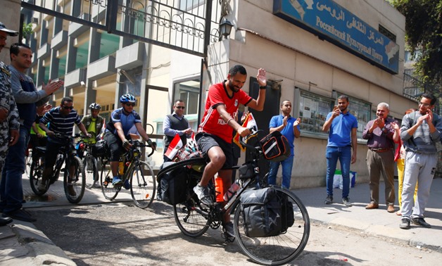 Egyptian cyclist Mohamed Nofal is greeted by his supporters as he exits Russian Cultural Center as he cycles to Russia for the 2018 Fifa World Cup after Egypt qualified for the first time in 28 years, in Cairo, Egypt, April 7, 2018. REUTERS/Amr Abdallah D