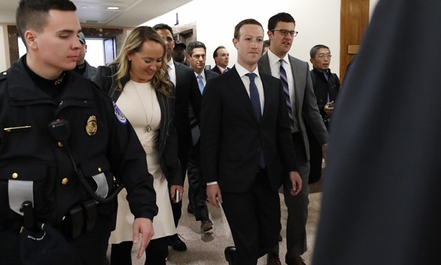 Facebook CEO Mark Zuckerberg walks to a meeting with Senator John Thun. Reuters
