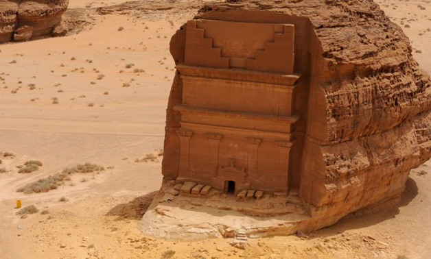 A picture taken on April 1, 2018 shows an aerial view of the Qasr al-Farid tomb (The Lonely Castle) carved into rose-coloured sandstone in Madain Saleh, a UNESCO World Heritage site, near Saudi Arabia's northwestern town of al-Ula.The tombs, some containi