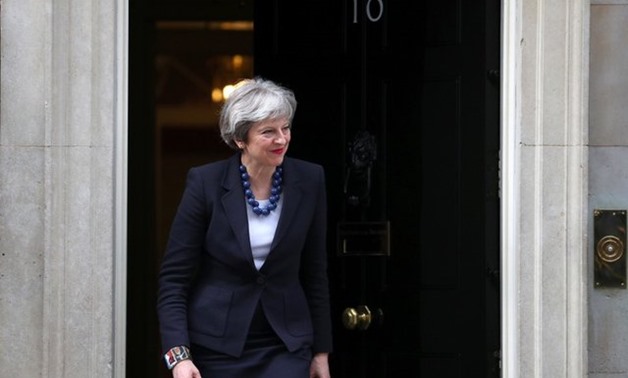 Britain's Prime Minister Theresa May walks out of 10 Downing Street to greet Portugal's Prime Minister Antonio Costa in London, April 10, 2018. REUTERS/Hannah Mckay