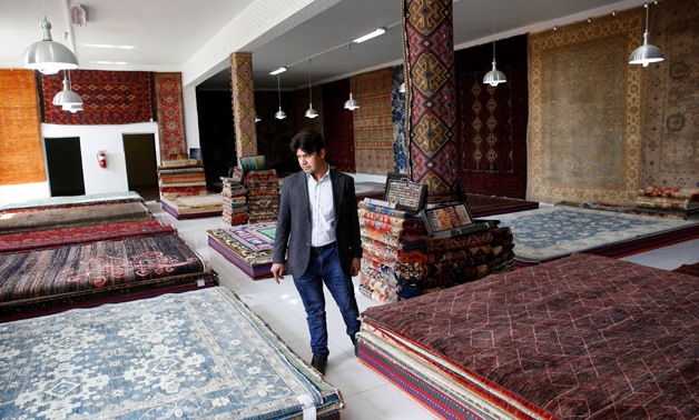 A vendor walks at the Afghanistan Rug and Carpet Center show room in Kabul, Afghanistan April 1, 2018. Picture taken April 1, 2018. REUTERS/Mohammad Ismail
