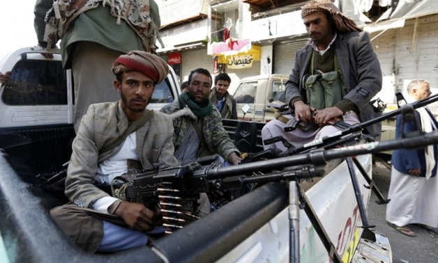 Houthi rebels in front of the residence of former president Ali Abdullah Saleh in Sanaa - AFP