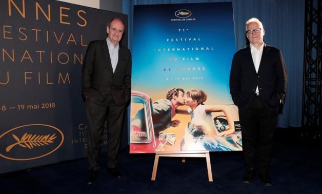 Cannes Film festival general delegate Thierry Fremaux and Cannes Film festival president Pierre Lescure (L) pose in front of the official poster for the 71st Cannes Film Festival after a news conference to announce the official selection, in Paris, France