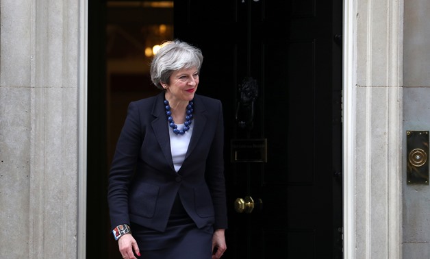 Britain's Prime Minister Theresa May walks out of 10 Downing Street to greet Portugal's Prime Minister Antonio Costa in London, April 10, 2018. REUTERS/Hannah Mckay
