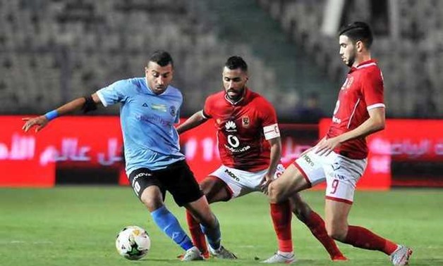 FILE - Al-Ahly’sWalidAzzarou and HossamAshour facing El-Dakhleya’s midfielder