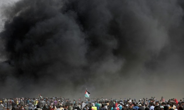 Palestinian protesters gather near the Gaza-Israel border on April 13, 2018

