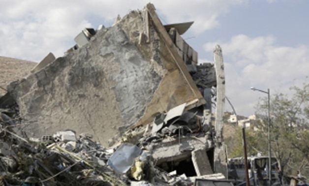 This picture taken on April 14, 2018 shows the wreckage of a building described as part of the Scientific Studies and Research Centre compound in the Barzeh district, north of Damascus, during a press tour organised by the Syrian information ministry. The