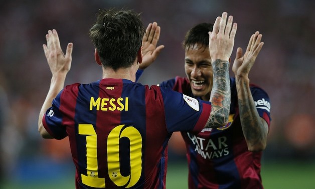 Lionel Messi celebrates with Neymar after scoring the first goal for Barcelona during the Spanish King's Cup Final between Athletic Bilbao and FC Barcelona at Nou Camp, Barcelona, Spain, May 30, 2015. — Reuters