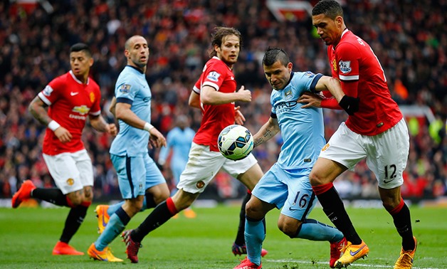 Manchester City's Sergio Aguero in action with Manchester United's Chris Smalling during the English Premier League soccer match between Manchester United and Manchester City at Old Trafford Stadium, Manchester, England, Sunday, April 12, 2015 (Photo: Reu