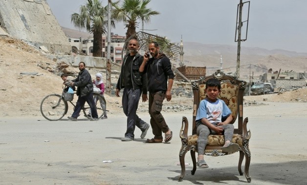 Civilians in the former rebel Syrian town of Douma on the outskirts of Damascus on April 17, 2018 after the Syrian army declared that all anti-regime forces have left Eastern Ghouta
