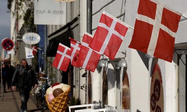 FILE PHOTO: Danish flags are pictured outside a cafe at the famous landmark Nyhavn in Copenhagen, Denmark April 18, 2017. REUTERS/Fabian Bimmer/File Photo