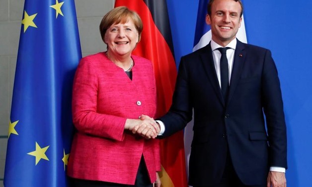 German Chancellor Angela Merkel and French President Emmanuel Macron shake hands after a news conference at the Chancellery in Berlin, Germany, May 15, 2017. REUTERS/Fabrizio Bensch