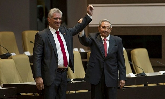 The National Assembly broke into applause as Cuba's new President Miguel Diaz-Canel walked to the front and embraced Raul Castro
