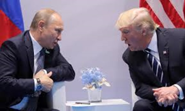 U.S. President Donald Trump speaks with Russian President Vladimir Putin during their bilateral meeting. REUTERS/Carlos Barria