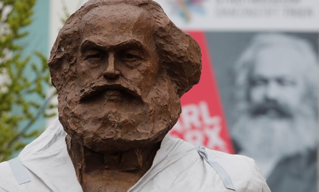 Workers set up a bronze sculpture of Karl Marx in his hometown Trier, Germany, April 13, 2018. REUTERS/Wolfgang Rattay