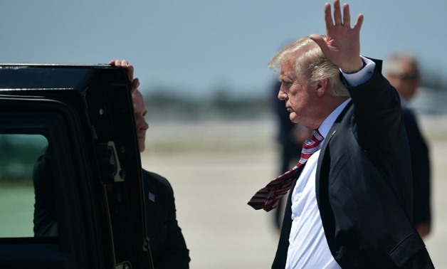 Unable to shake legal problems: President Donald Trump stepping off Air Force One in West Palm Beach, Florida on April 18, 2018
