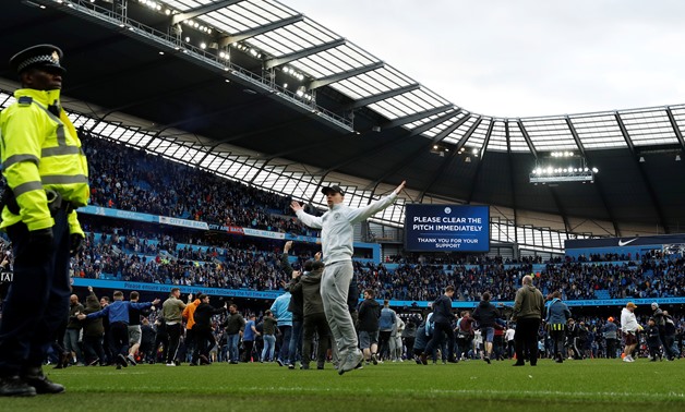 
Soccer Football - Premier League - Manchester City v Swansea City - Etihad Stadium, Manchester, Britain - April 22, 2018 Manchester City fans invade the pitch after the game Action Images via Reuters/Lee Smith 
