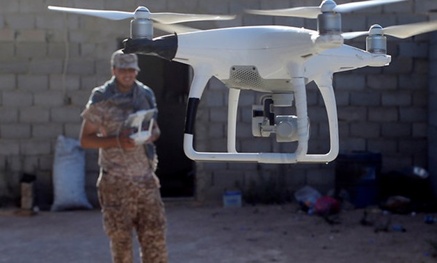 A fighter of Libyan forces allied with the U.N.-backed government uses a drone to observe Islamic State fighters positions in Sirte, Libya in 2016. (Reuters- File Photo)