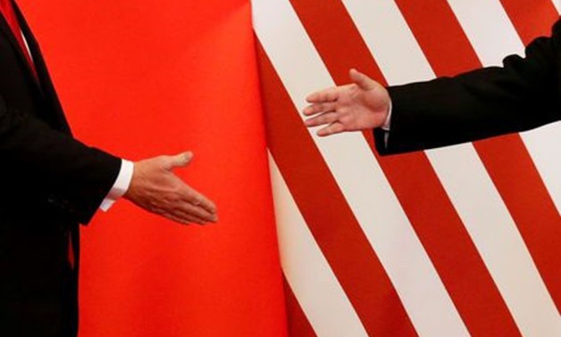 FILE PHOTO: U.S. President Donald Trump and China's President Xi Jinping shake hands after making joint statements at the Great Hall of the People in Beijing, China, November 9, 2017. REUTERS/Damir Sagolj/File Photo
