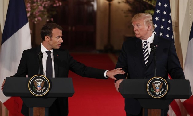 French President Emmanuel Macron reaches out to U.S. President Donald Trump as he speaks during their joint news conference at the White House in Washington, U.S., April 24, 2018. REUTERS/Jonathan Ernst