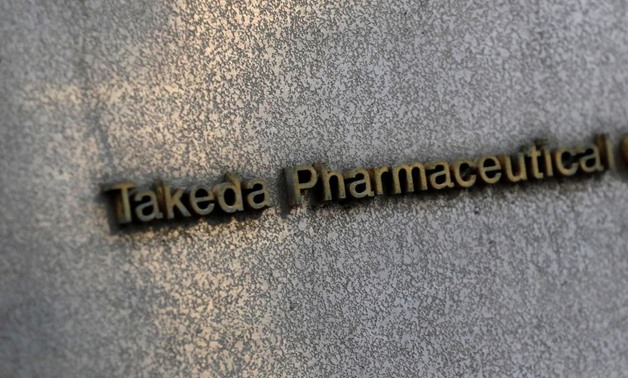 FILE PHOTO: Takeda Pharmaceutical's signboard is seen on its headquarters building in Tokyo, Japan January 30, 2018. REUTERS/Kim Kyung-Hoon/File Photo

