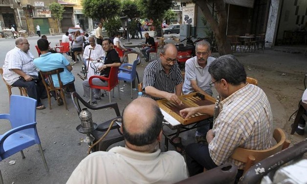 Men play backgammon at a cafe in Cairo August 18, 2013. REUTERS/Muhammad Hamed