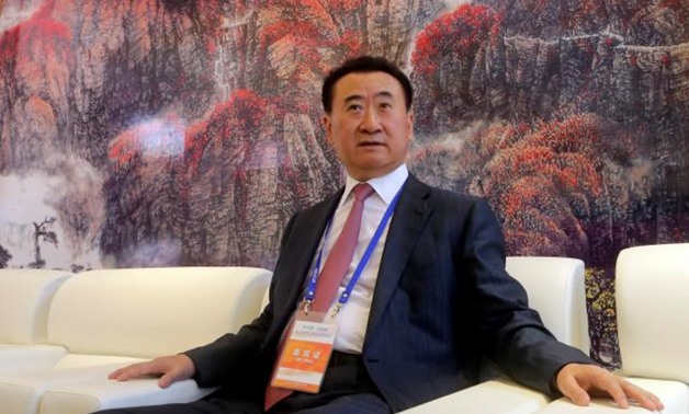FILE PHOTO: Wang Jianlin, chairman of Chinese property developer Dalian Wanda Group, sits in a meeting room as he arrives for the launch ceremony of the Qingdao Oriental Movie Metropolis on the outskirts of Qingdao, Shandong province, September 22, 2013. 