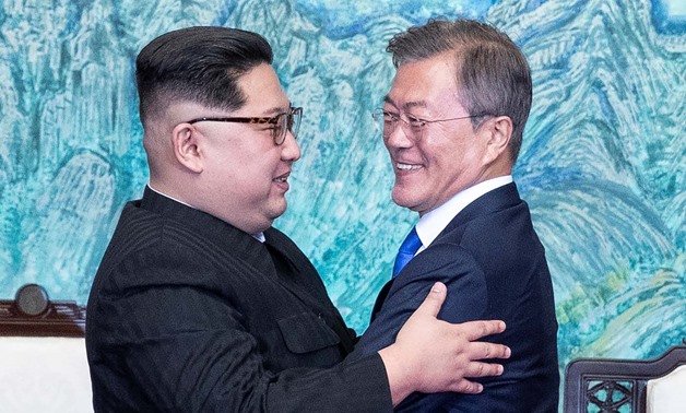 South Korean President Moon Jae-in and North Korean leader Kim Jong Un embrace at the truce village of Panmunjom