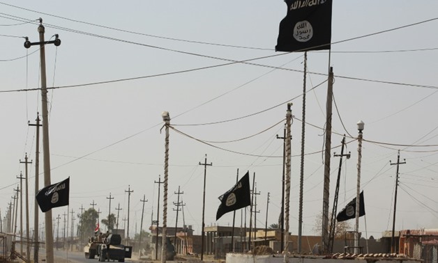 Islamic State group flags in the northern Iraqi town of Sharqat on September 22, 2017
