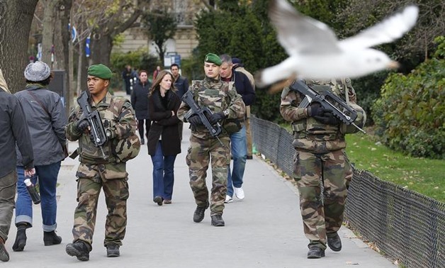 French military patrol near the Eiffel Tower the day after a series of deadly attacks in Paris, November 14, 2015. REUTERS/Yves Herman