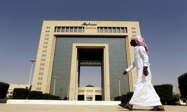A man walks past the headquarters of Saudi Basic Industries Corp (SABIC) in Riyadh, Saudi Arabia October 27, 2013. REUTERS/Faisal Al Nasser/File Photo