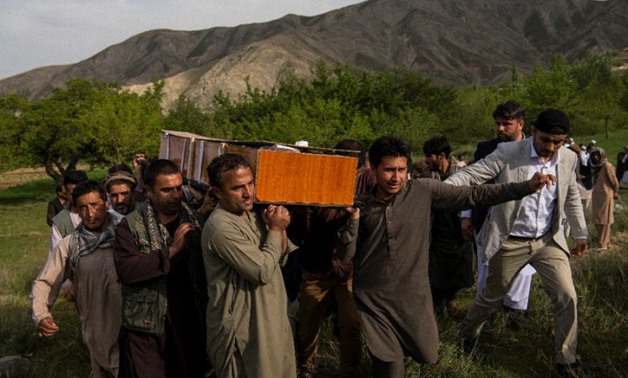 Relatives and friends of late AFP photographer Shah Marai carry his coffin at his burial outside Kabul
