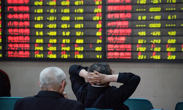 Investors look at an electronic board showing stock information at a brokerage house in Nanjing, Jiangsu province, China April 16, 2018. REUTERS/Stringer