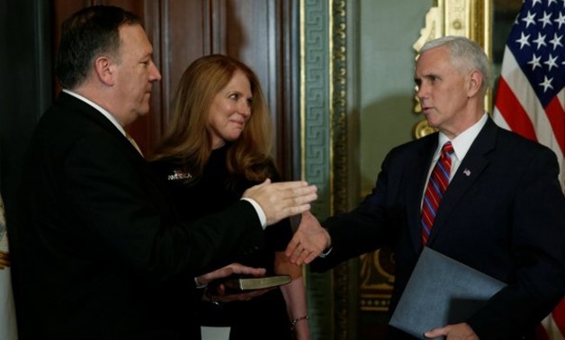 .S. Vice President Mike Pence (R) finishes swearing in Mike Pompeo, flanked by his wife Susan Pompeo, to be director of the Central Intelligence Agency (CIA) in the vice presidents ceremonial office in the Eisenhower Executive Office Building at the White