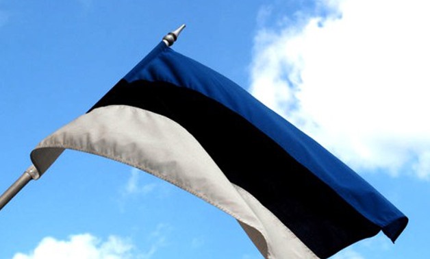 An Estonian flag waving in the air.- CC via Wikimedia