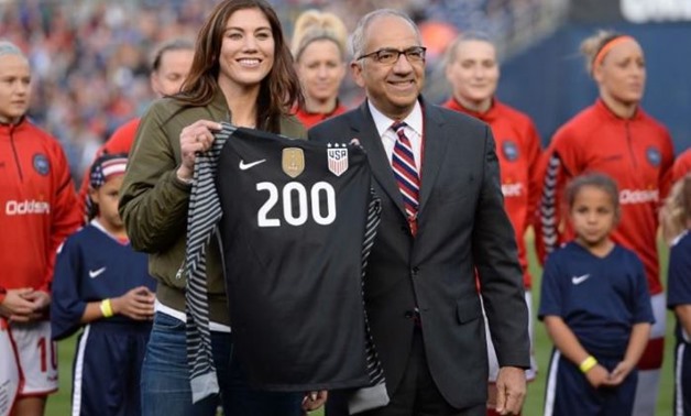 FILE PHOTO - Jan 21, 2018; San Diego, CA, USA; United States soccer vice president Carlos Cordeiro (right) presents former player Hope Solo a commemorative jersey celebrating her 200th appearance for the womens national team before a game against Denmark 