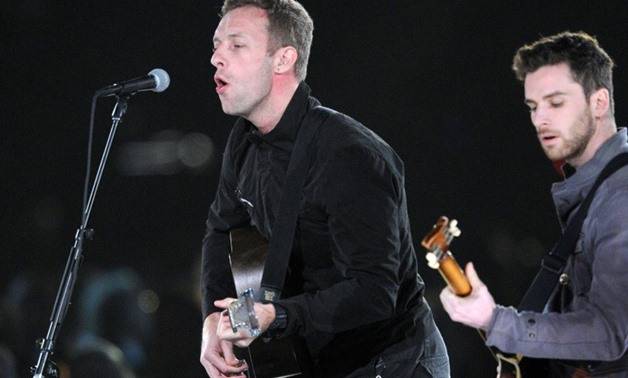Chris Martin (L), shown performing in 2012 with Coldplay bandmate Guy Berryman, is planning a Buenos Aires concert as part of efforts to reduce poverty.