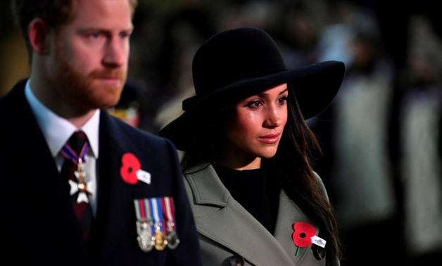 Britain's Prince Harry and his fiancee Meghan Markle attend the Dawn Service at Wellington Arch to commemorate Anzac Day in London, Britain, April 25, 2018. REUTERS/Toby Melville/Pool
